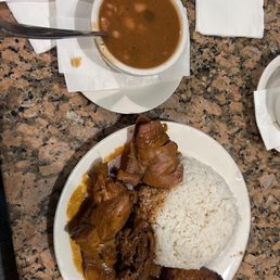 Rice, stew chicken, and beans on the side