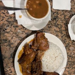 Caridad Restaurant - Rice, stew chicken, and beans on the side