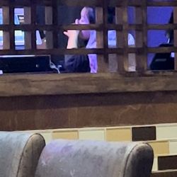 Kaji Sushi & Lounge - Bartender flossing teeth at bad