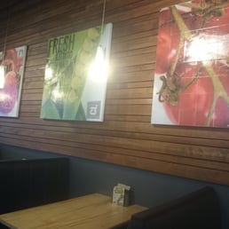 a wooden wall with posters on it