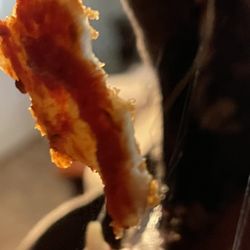 Papa Johns Pizza - One side of the papadia hanging from a string of hair.