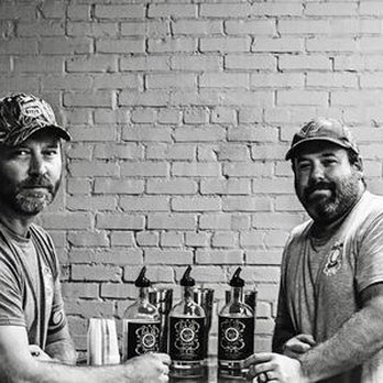Lick Life Spirits - two men shaking hands with bottles - Distilleries Near Me - Zebulon, North Carolina Lick Life Spirits - two men shaking hands with bottles - Distilleries Near Me - Zebulon, North Carolina