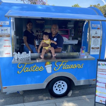Tastee Flavors - a man and a baby in a food truck - Food Trucks Near Me Tastee Flavors - a man and a baby in a food truck - Food Trucks Near Me
