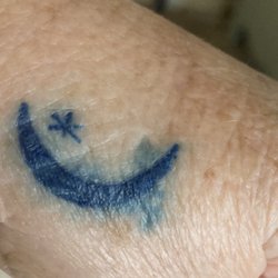 Clover Tattoo & Body Piercing - He didn't finish the star it's far from being yellow, and it bled out of the lines and the moon isn't even filled in .