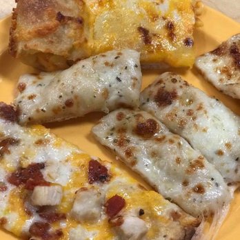 Cicis Pizza - four slices of pizza on a yellow plate - Pizza Near Me - Pigeon Forge, Tennessee