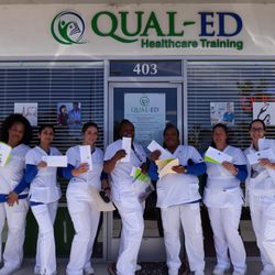 QUAL-ED - New graduates showing off their passing CNA board exam.