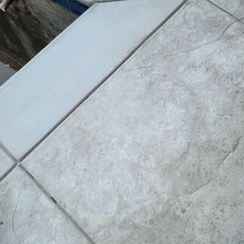 Merced Pools - Beautiful stamped concrete - A photograph showing a tiled floor with a corner, grout lines, and a section of a step or ledge, focusing on the tile pattern and surface. - Pool & Hot Tub Service Near Me - Merced, California