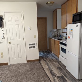 Ocean Suites - kitchenette of main bedroom, the bathroom is at end of hall (2nd bedroom is to the left off the hall) - Hotels Near Me - Brookings, Oregon