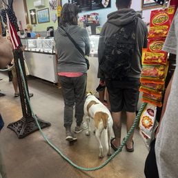 In the line for ice cream. In the line for ice cream.