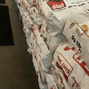 Five Guys - a large pile of bags of food - Fast Food Near Me - Dubuque, Iowa