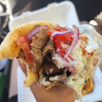 Sofia's Mediterranean Grill - a hand holding a pita sandwich - Greek Near Me - Hasbrouck Heights, New Jersey Sofia's Mediterranean Grill - a hand holding a pita sandwich - Greek Near Me - Hasbrouck Heights, New Jersey