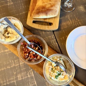 Oak Valley Vineyard - The bread board with a trio of dippings; hummus, a tomatoe chutney and an artichoke dip. - New American Near Me - San Antonio, Texas Oak Valley Vineyard - The bread board with a trio of dippings; hummus, a tomatoe chutney and an artichoke dip. - New American Near Me - San Antonio, Texas