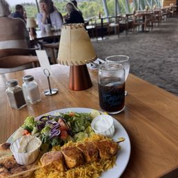 Chicken kebab on a smoky sumac rice with Mediterranean sides of hummus, tzatziki, pita and salad. Only $16 Canadian. Chicken kebab on a smoky sumac rice with Mediterranean sides of hummus, tzatziki, pita and salad. Only $16 Canadian.