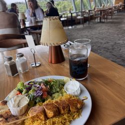Baratie - Chicken kebab on a smoky sumac rice with Mediterranean sides of hummus, tzatziki, pita and salad. Only $16 Canadian.