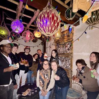 Hugman's Oasis - Outside area and each of us has a different drink from the holiday menu - Tiki Bars Near Me - San Antonio, Texas Hugman's Oasis - Outside area and each of us has a different drink from the holiday menu - Tiki Bars Near Me - San Antonio, Texas