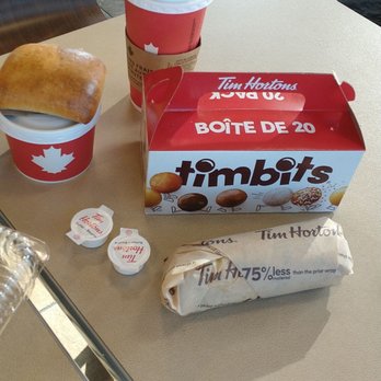 Tim Hortons - a cup of coffee and a sandwich on a table - Coffee & Tea Near Me - Sarnia, Ontario Tim Hortons - a cup of coffee and a sandwich on a table - Coffee & Tea Near Me - Sarnia, Ontario