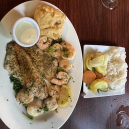 a plate of shrimp, rice, and vegetables