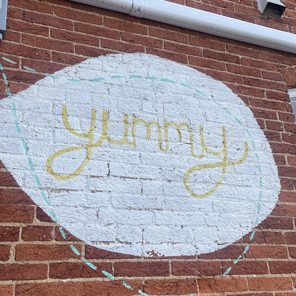 a sign on a brick building a sign on a brick building