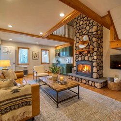 The Haus Windham - Relax in the warmth of our rustic-modern living room, where towering ceilings and cozy fires meet stunning natural vistas.