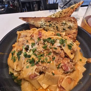 Burtons Grill & Bar - Pappardelle Bolognese fresh pasta, traditional meat sauce, parmesan, italian parsley, garlic ciabatta toast - New American Near Me - Huntersville, North Carolina Burtons Grill & Bar - Pappardelle Bolognese fresh pasta, traditional meat sauce, parmesan, italian parsley, garlic ciabatta toast - New American Near Me - Huntersville, North Carolina