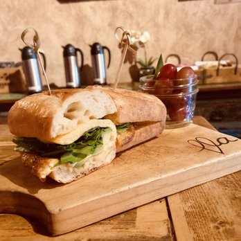 Ella Cafe - Egg sandwich with spinach, Parmesan and avocado. Paired with yummy grapes. - Coffee & Tea Near Me - Plantation, Florida