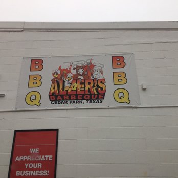 Alzer's BBQ - Sign on wall over truck - Barbeque Near Me - Cedar Park, Texas
