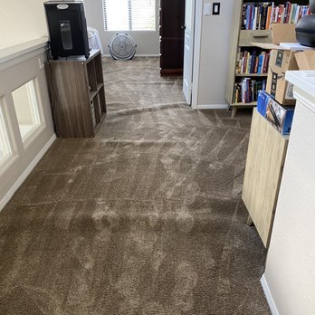 Carpet In - a living room with bookshelves and a television - Carpeting Near Me - Norco, California