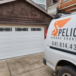 Pelican Garage Doors - Raised panel door with tinted windows in Pacific City