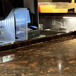 Red Lobster - Lemonade. On the bar  serving it to customers. plastic cup floating in it.