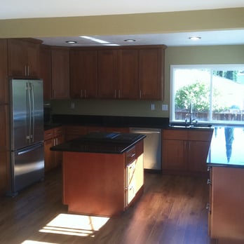 Adam Lewis Construction Company - a kitchen with wood cabinets and stainless steel appliances - General Contractors Near Me - Livermore, California