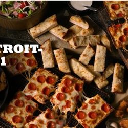 Jet's Pizza - Jet's Detroit-Style pizza is a light airy center, loaded with toppings, surrounded by caramelized cheese and a crispy, square, golden crust