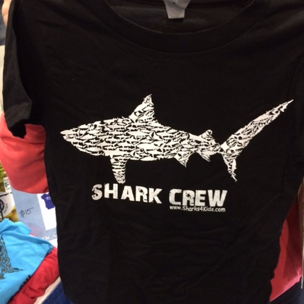 Shark Con - Cool shirts.  This one came in both kid and adult sizes. - Festivals Near Me - Tampa, Florida