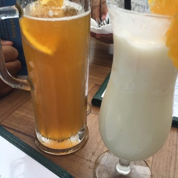 Buzzard's Roost Grill & Pub - His 22oz beer and hers pina colada with Meyer's floater rum - Seafood Near Me - Key Largo, Florida Buzzard's Roost Grill & Pub - His 22oz beer and hers pina colada with Meyer's floater rum - Seafood Near Me - Key Largo, Florida