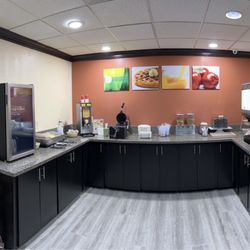 Breakfast details show eggs, bacon and sausage next to fridge, waffle area, cereal and toaster with juice dispenser on end