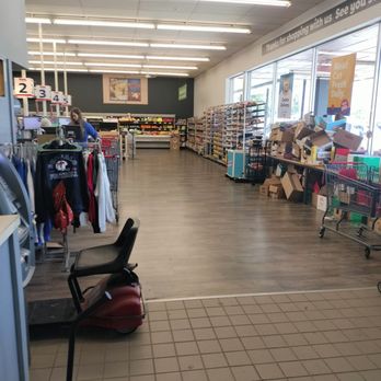 Save A Lot - Entrance - Interior of a discount grocery store showing aisles with shelves stocked with products, a checkout counter, and a customer shopping. - Grocery Near Me - Chaffee, New York