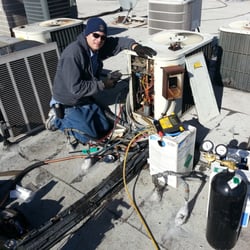 Air conditioning repair on a roof.