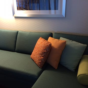 SpringHill Suites by Marriott Bloomington - Bright colors on the L-shaped couch - Hotels Near Me - Bloomington, Indiana SpringHill Suites by Marriott Bloomington - Bright colors on the L-shaped couch - Hotels Near Me - Bloomington, Indiana