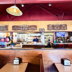 Village Host Pizza & Grill - View of counter from one dining area