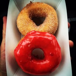 Cherry yeast donut and a cinnamon sugar cake donut