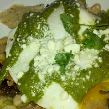The Cafe - Delicious stick to your ribs homey chillaquilles topped with over easy eggs and chimchirri sauce on pozole made with hominy! - Bakeries Near Me - Ames, Iowa