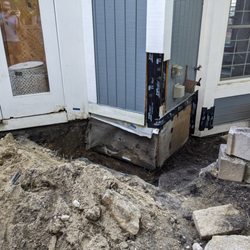 Excavating to access rotted wood below the patio