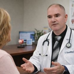 Aspen View - Dr. with Patient going over her medical history in order to create a custom healthcare plan.