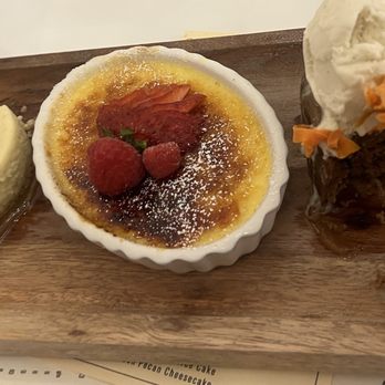 Peche Modern Coastal - A trio of Creme Brulee, Toffee Cake, and Bourbon Pecan Cheesecake - Seafood Near Me - Peachtree Corners, Georgia