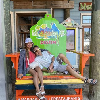 Margaritaville - Destin - two people sitting on a bench - American Near Me - Destin, Florida Margaritaville - Destin - two people sitting on a bench - American Near Me - Destin, Florida