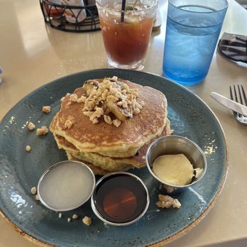Holoholo Grill - Banana Mac Nut Pancakes...coconut syrup on left - Hawaiian Near Me - Koloa, Hawaii Holoholo Grill - Banana Mac Nut Pancakes...coconut syrup on left - Hawaiian Near Me - Koloa, Hawaii