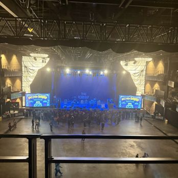 The Anthem - View of the stage - hours before the show. - The image shows the stage at The Anthem in Washington, DC, with a crowd gathered in front, and screens displaying event information. - Music Venues Near Me - Washington, DC, District of Columbia