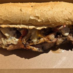 The Current - Texas Cheesesteak - Brisket, sautéed pepper and onions, house horseradish and black pepper aoilo, pepperjack cheese on a. French Roll