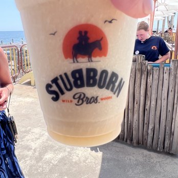 Stubborn Brothers - a person holding up a drink - New American Near Me - North Wildwood, New Jersey Stubborn Brothers - a person holding up a drink - New American Near Me - North Wildwood, New Jersey