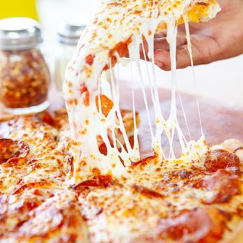 Rocko's Pizza - a hand holding a slice of pizza - Pizza Near Me - Terrell, Texas Rocko's Pizza - a hand holding a slice of pizza - Pizza Near Me - Terrell, Texas