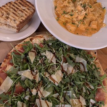 Mizza - Complimentary bread with Olive Oil + Balsamic Vinegar, Salmon and Farafalla Pasta, Arugula and Prosciutto Pizza, - Italian Near Me - Santa Barbara, California